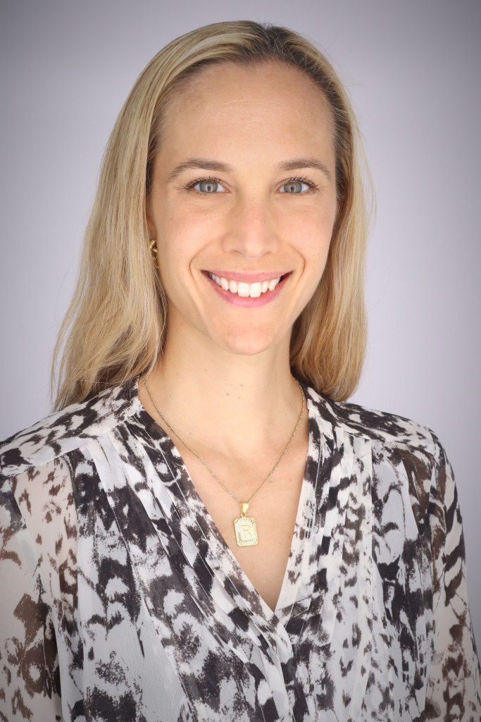 Headshot of Rachel Northrop, a white woman with blond hair wearing a black and white blouse.